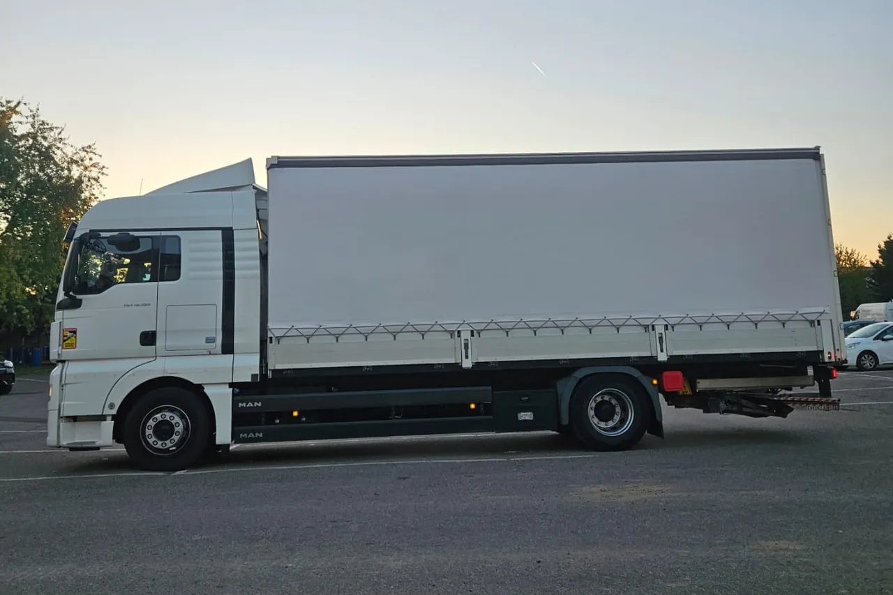 Le porteur MAN TGX de profil : cabine et caisse bâchée sur deux essieux.